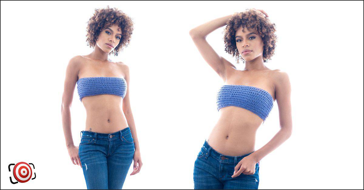 A backlit beauty in a blue top and jeans.